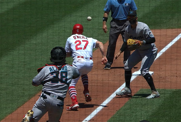 Marlins catcher Alfaro running a Cardinals base runner (O'Neill) back up the third base line and making a throw to a waiting third baseman