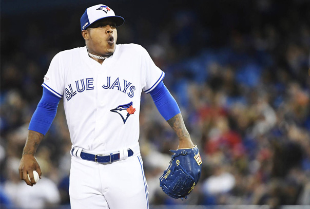 Marcus Stroman in Blue Jays jersey holding ball and taking a large breath on the mound