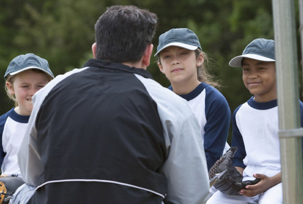 A coach talking to three players