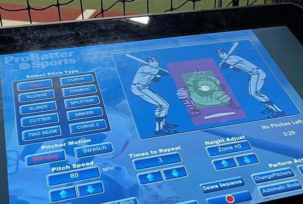 iPad with ProBatter Sports screen on it in front of a batting cage