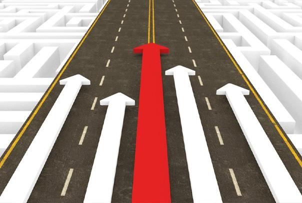Road with 5 arrows pointing up, four are white and the middle one is red.